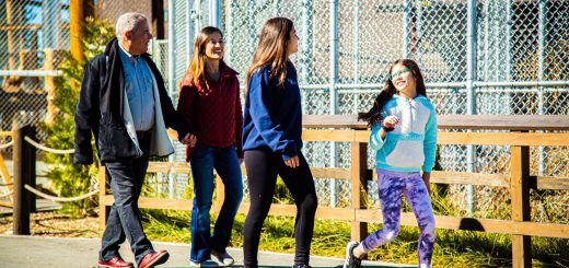 Family walking along Big Bear Alpine Zoo pathway during Run Wild Through Moonridge event