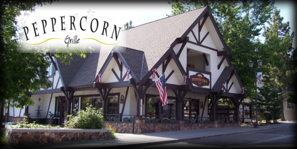The exterior of a restaurant called Peppercorn Grille is shown in Big Bear on a sunny day, with the restaurant's name and a logo overlaid on the image.