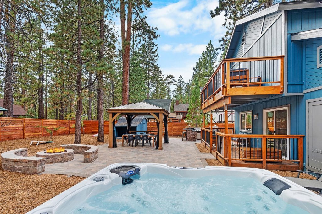 Big Bear cabin backyard with hot tub, fire pit, outdoor gazebo, and spacious patio area