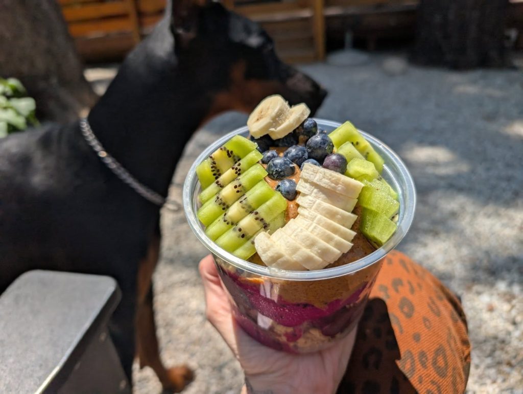 Fresh acai bowl from Frusion Juice & Coffee Bar topped with kiwi, blueberries, banana, and colorful fruit layers.