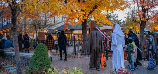 Visitors wearing costumes and enjoying a Halloween event in Big Bear Village during the autumn season