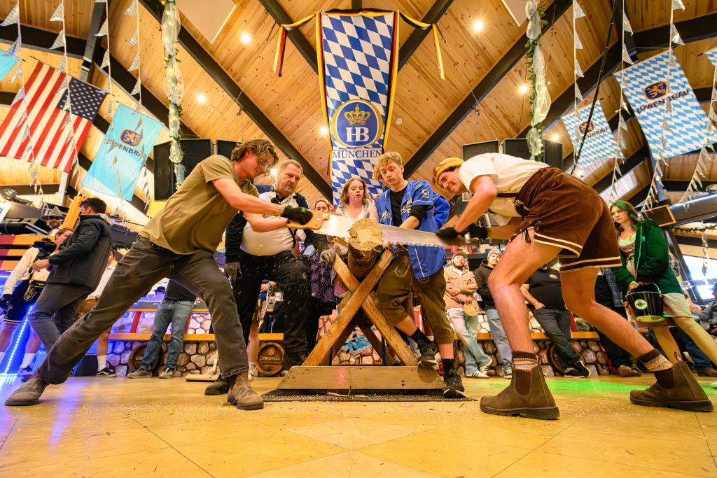 Guests participating in a lively Oktoberfest celebration with traditional games and decorations in Big Bear.