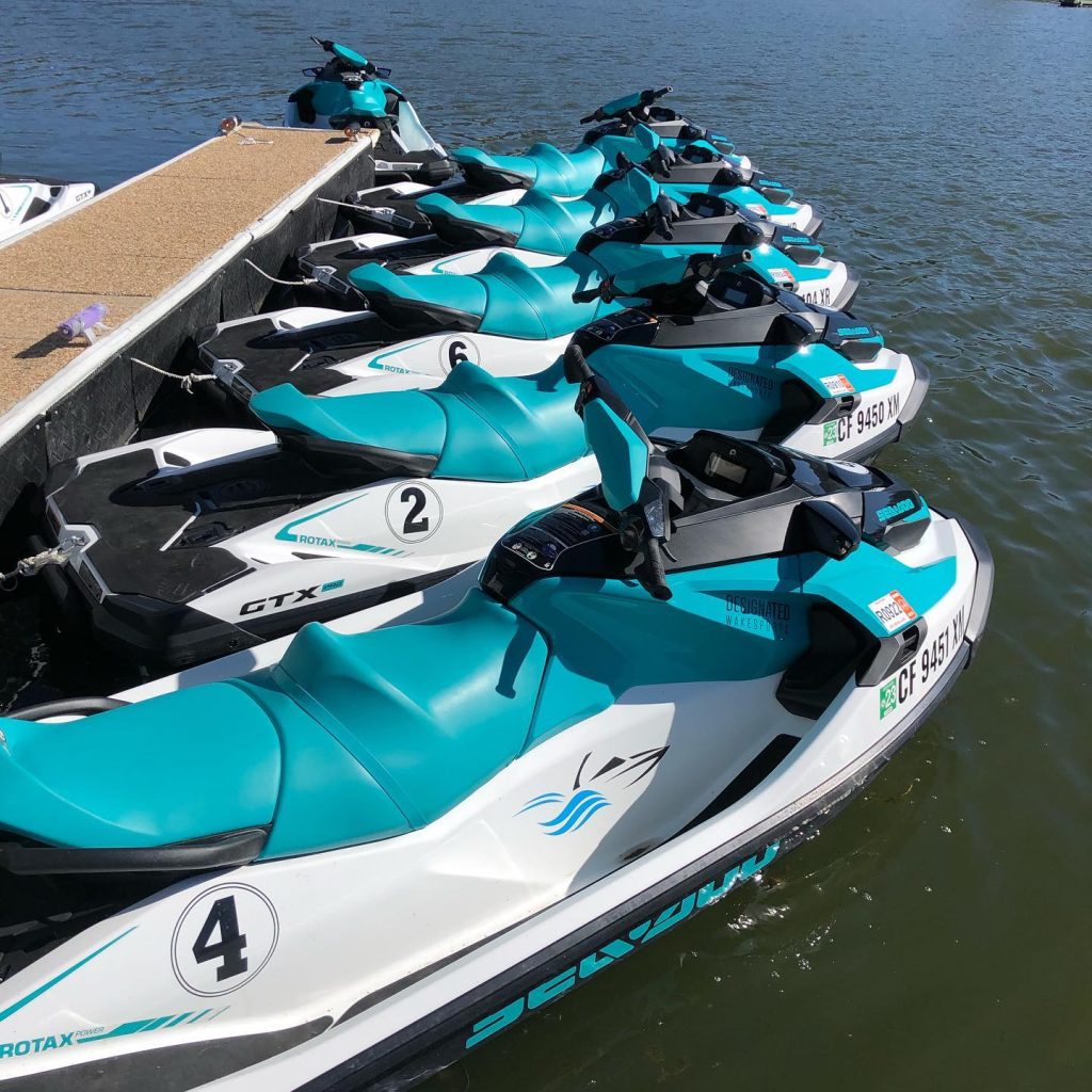 Row of jet skis docked on Big Bear Lake ready for a water adventure.