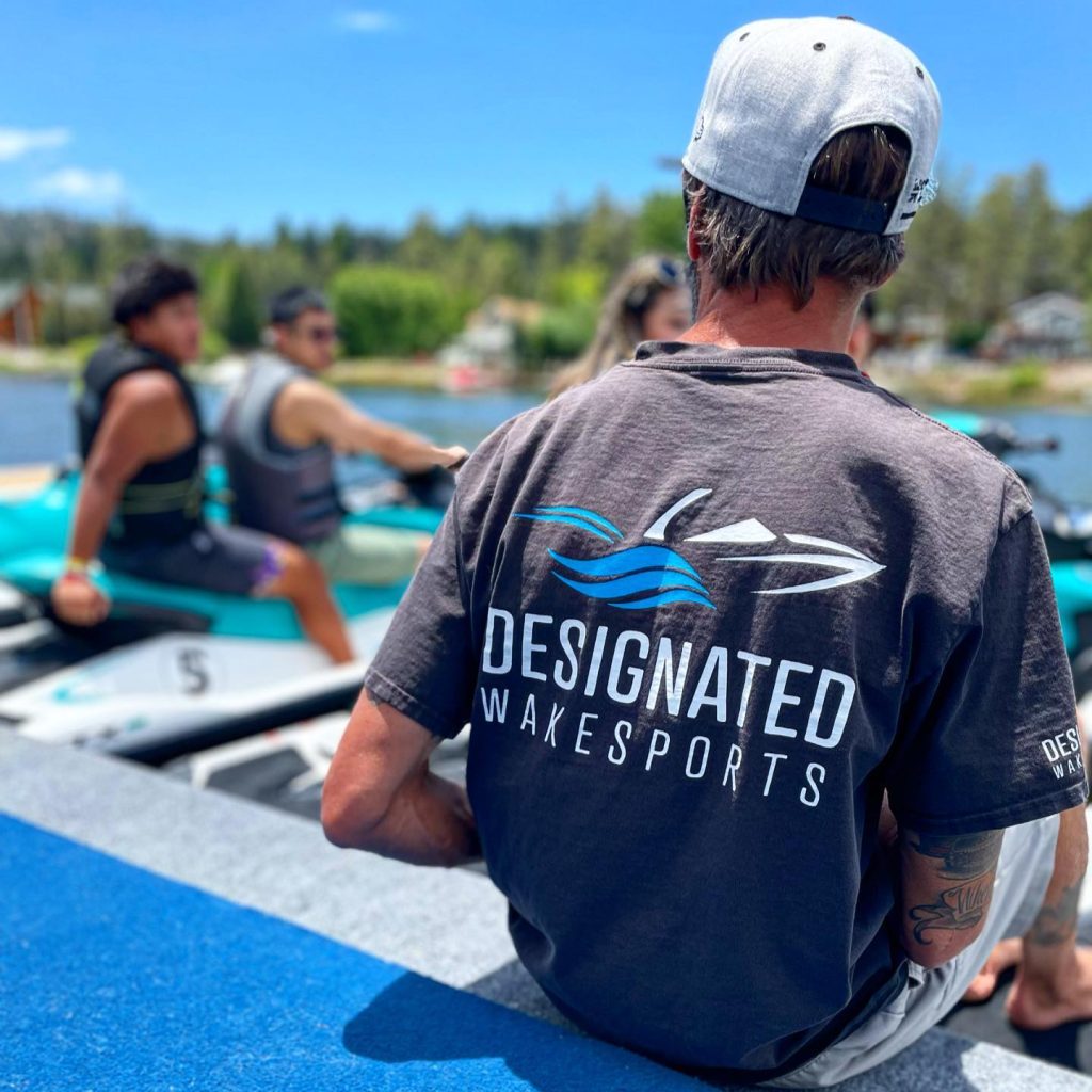 Designated Watersports team member preparing for a lake adventure with jet skis and water activities.