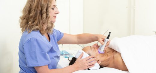 Spa-Tique By Margo skincare specialist standing near Big Bear Lake in professional scrubs.