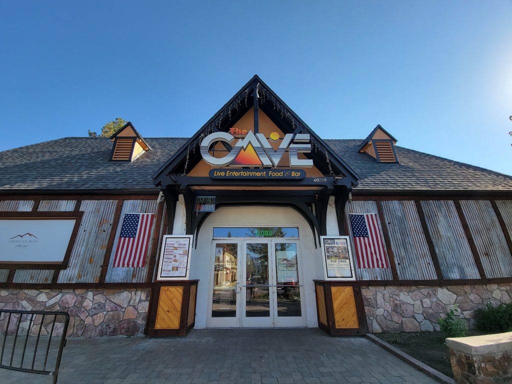 Exterior view of The Cave Big Bear restaurant and entertainment venue entrance