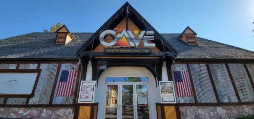 Exterior view of The Cave Big Bear restaurant and entertainment venue entrance