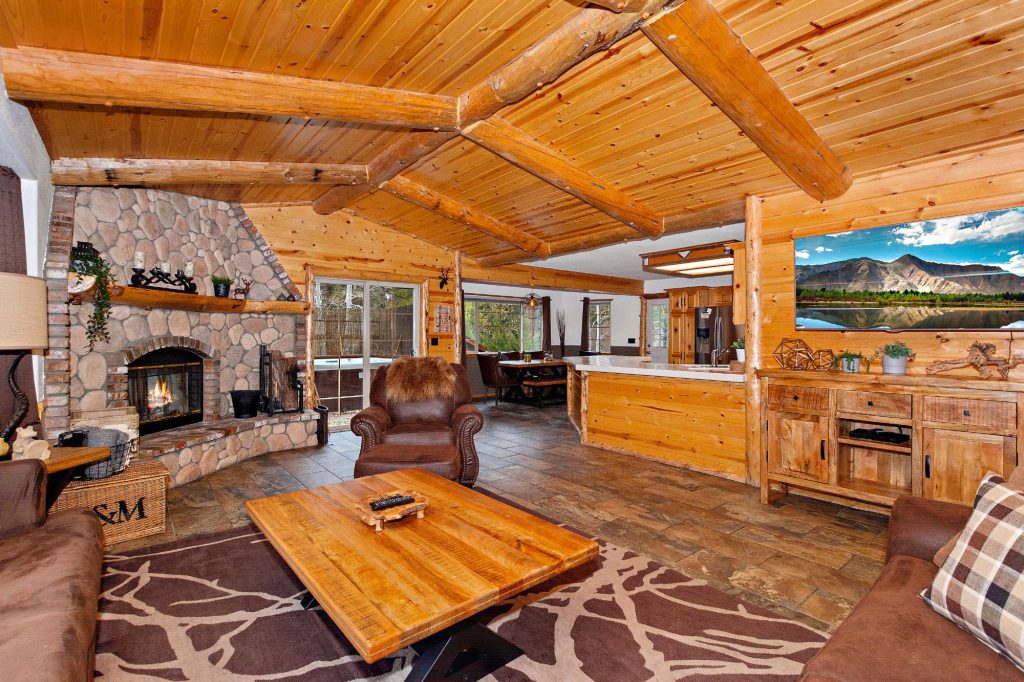 A cozy living room in The Crazy Bear cabin featuring a fireplace and a television, perfect for relaxation.