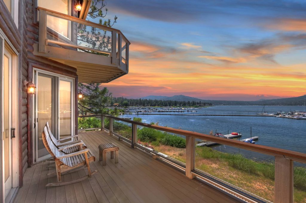 Lakefront balcony with rocking chairs overlooking Big Bear Lake at sunset