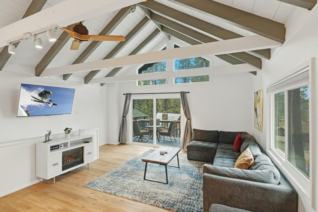 Bright The Landing on Fern living room with vaulted ceilings, fireplace, sectional sofa, and forest views