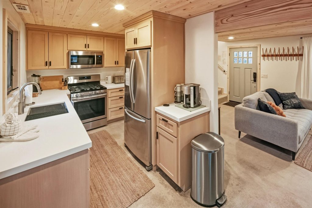 Contemporary kitchen with stainless steel appliances and light wood cabinetry in a mountain cabin