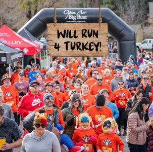 Big Bear Turkey Trot image of runners at starting line in orange shirts