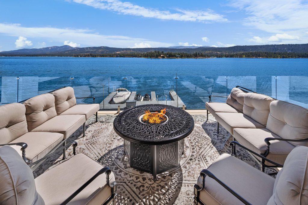 Luxury lakefront patio with firepit and dock overlooking Big Bear Lake