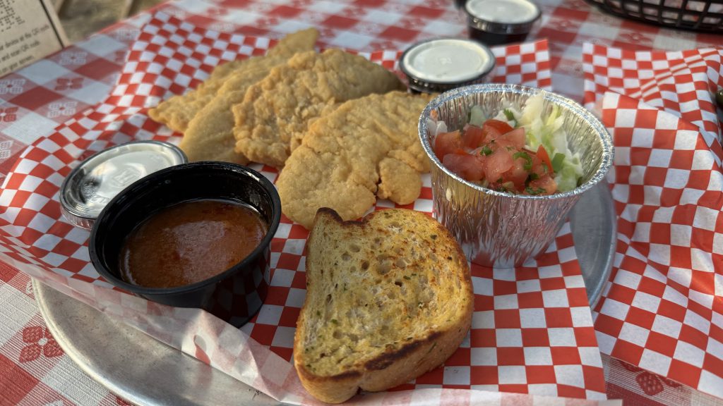 Fried chicken tenders served with dipping sauce, garlic bread, and fresh salad at Wyatt’s Grill and Saloon in Big Bear