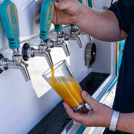 Fresh craft beer being poured from tap at Big Bear event with cold beverage service
