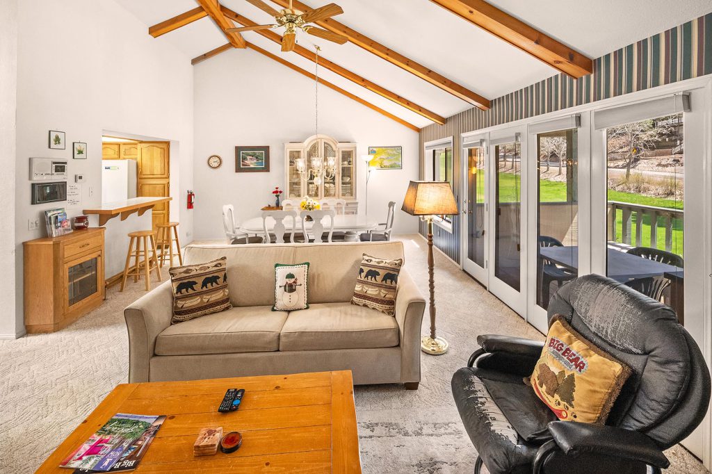 A cozy living room in Bear House, Big Bear, featuring a couch, coffee table, and a television.