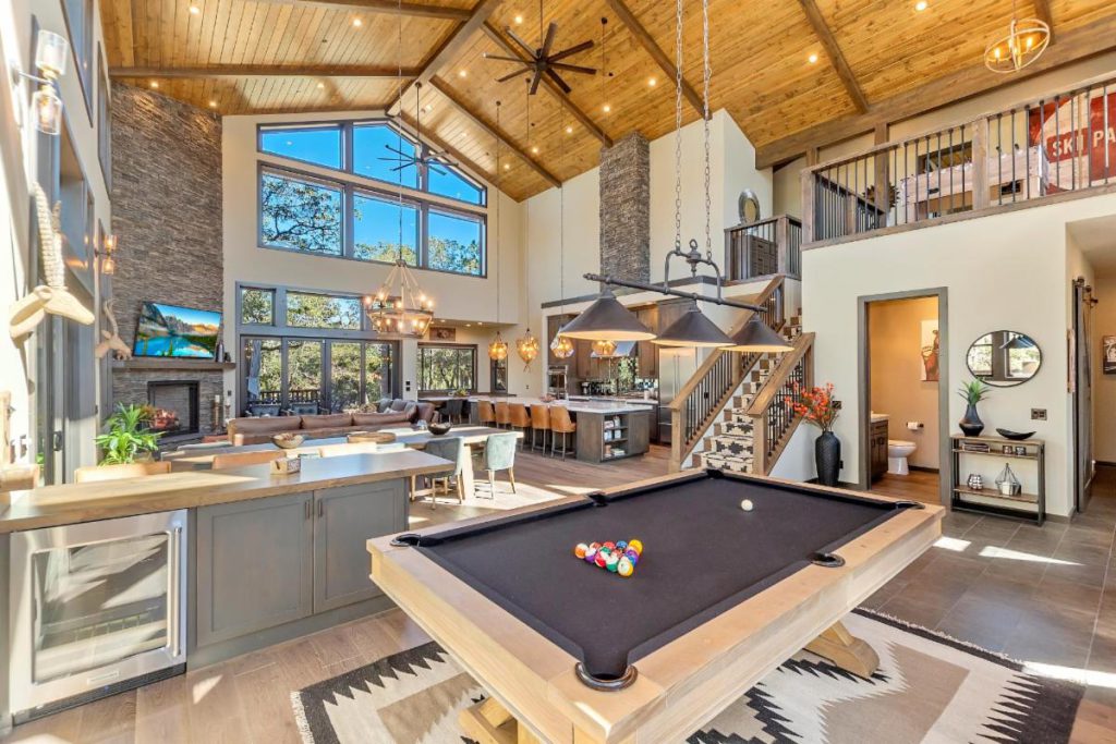 A luxurious Big Bear lodge with a billiards table, vaulted wooden ceilings, and a spacious living area.