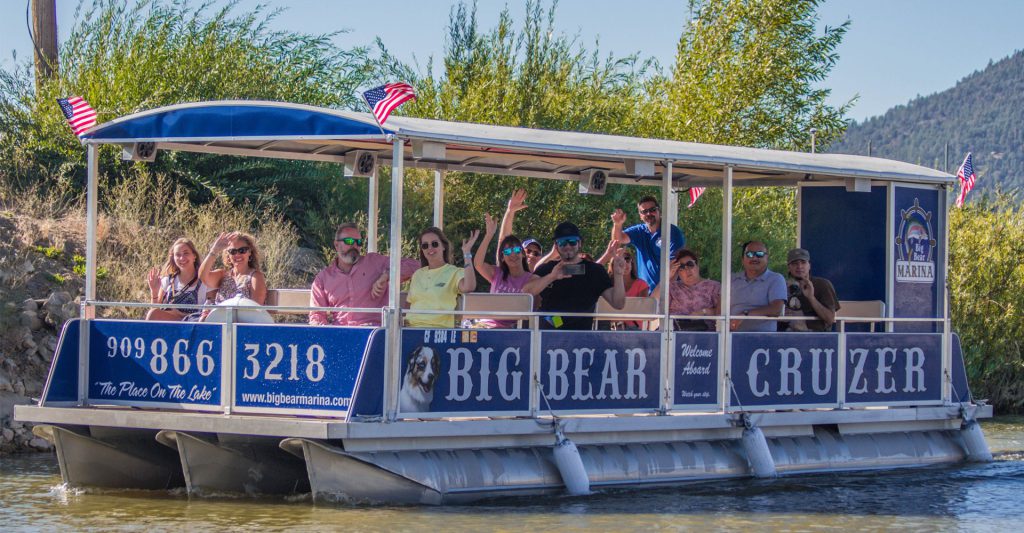 Big Bear Cruzer pontoon boat lake tour with guests enjoying scenic views on Big Bear Lake