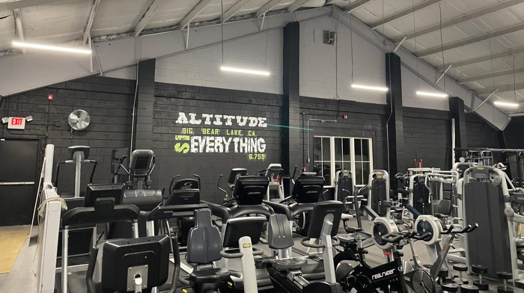 Gym interior with cardio and weight machines at Big Bear Altitude Training Center.