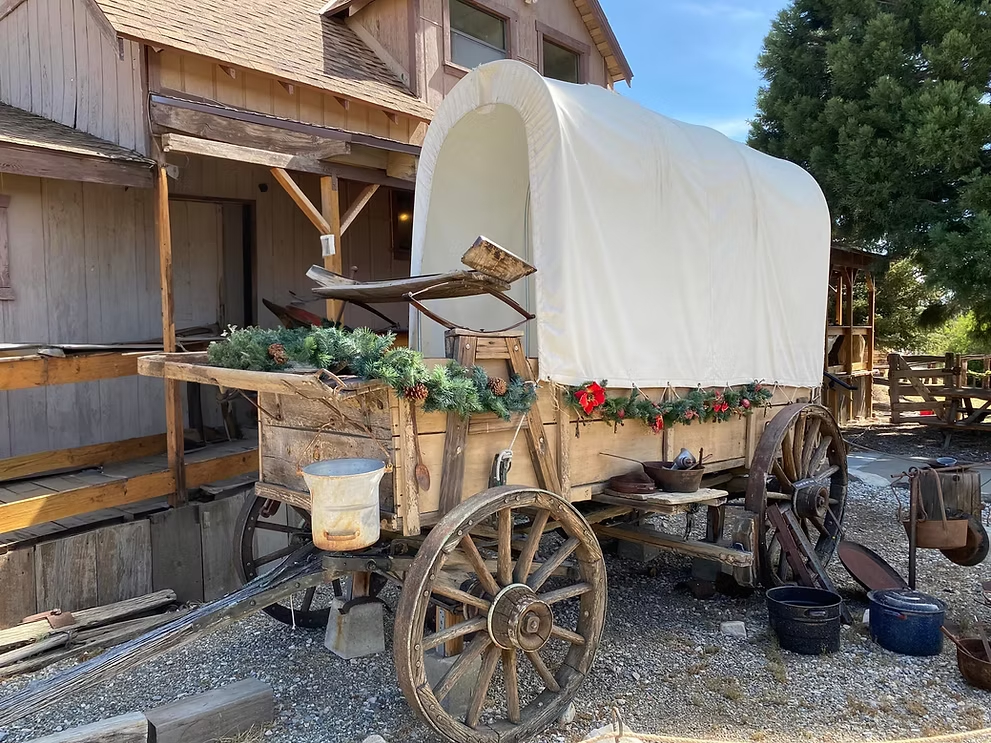 Historic covered wagon exhibit displayed outside the Big Bear Valley Historical Museum.