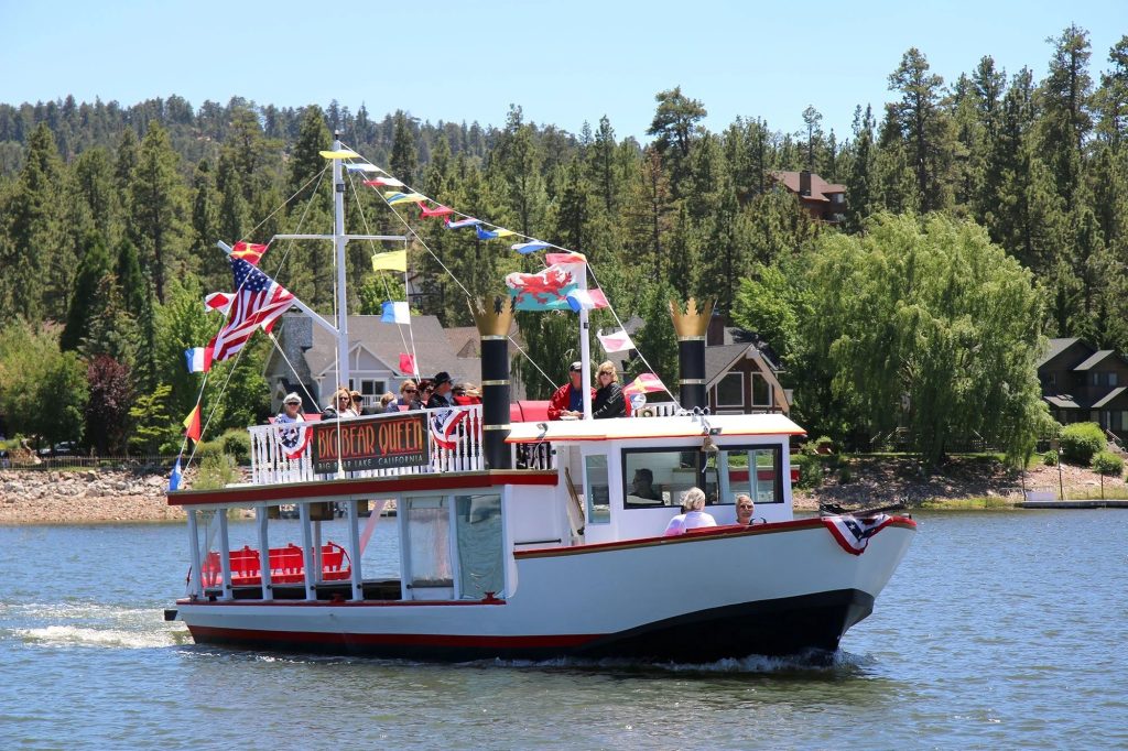 Big Bear Queen sightseeing boat cruising across Big Bear Lake with passengers enjoying scenic mountain views and lake experiences.