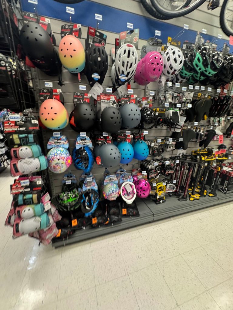 Display of bicycle helmets and cycling accessories inside Big 5 Sporting Goods.
