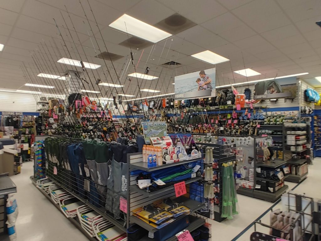 Fishing department inside Big 5 Sporting Goods with rods, tackle, and outdoor equipment.