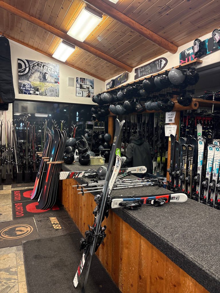 Interior of Blauer Ski & Board Shop in Big Bear featuring ski rentals, snowboards, helmets, and winter sports equipment.