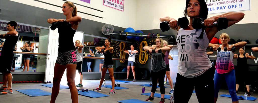 Group fitness class with dumbbell exercises at BodyTek Fitness in Big Bear