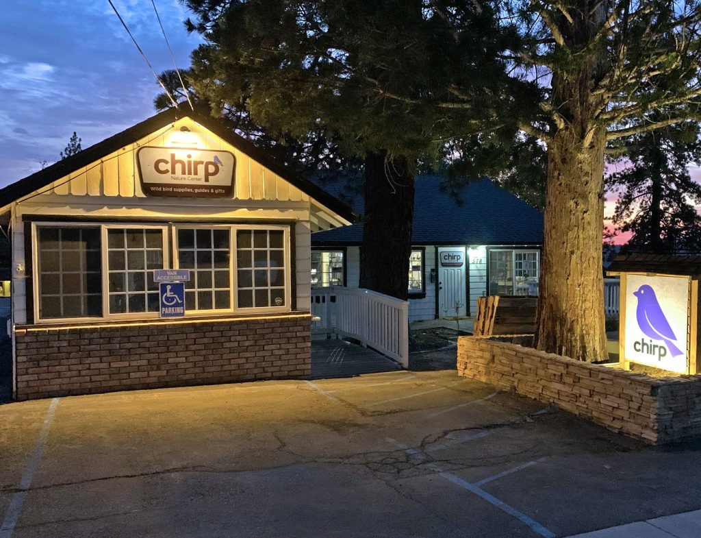 evening exterior view of Chirp Nature Center with illuminated sign in Big Bear Lake