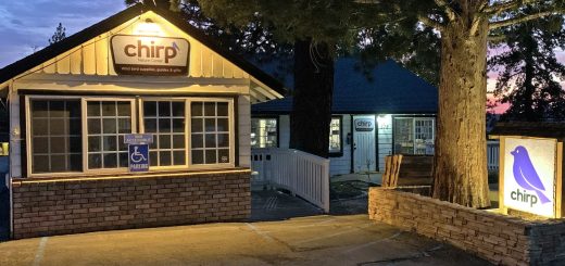 evening exterior view of Chirp Nature Center with illuminated sign in Big Bear Lake