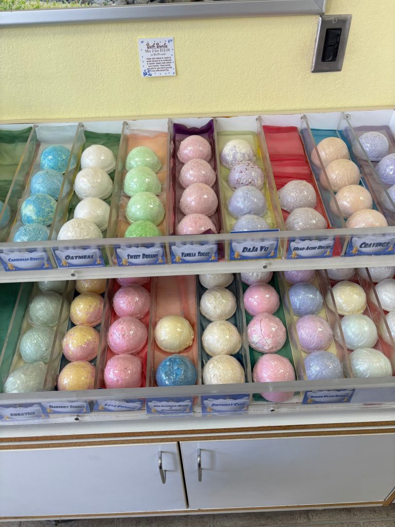 Colorful handmade bath bombs displayed inside The Bath Workshop in Big Bear Lake