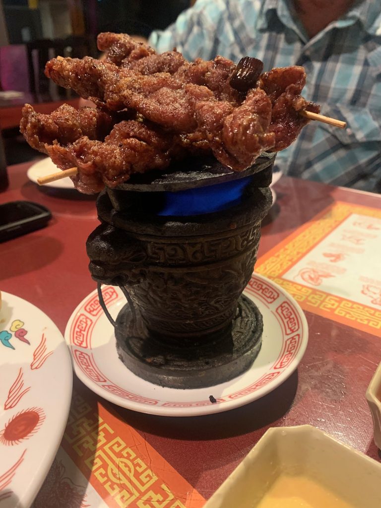sizzling skewered meat served on a traditional burner at Dynasty Chinese Restaurant Big Bear