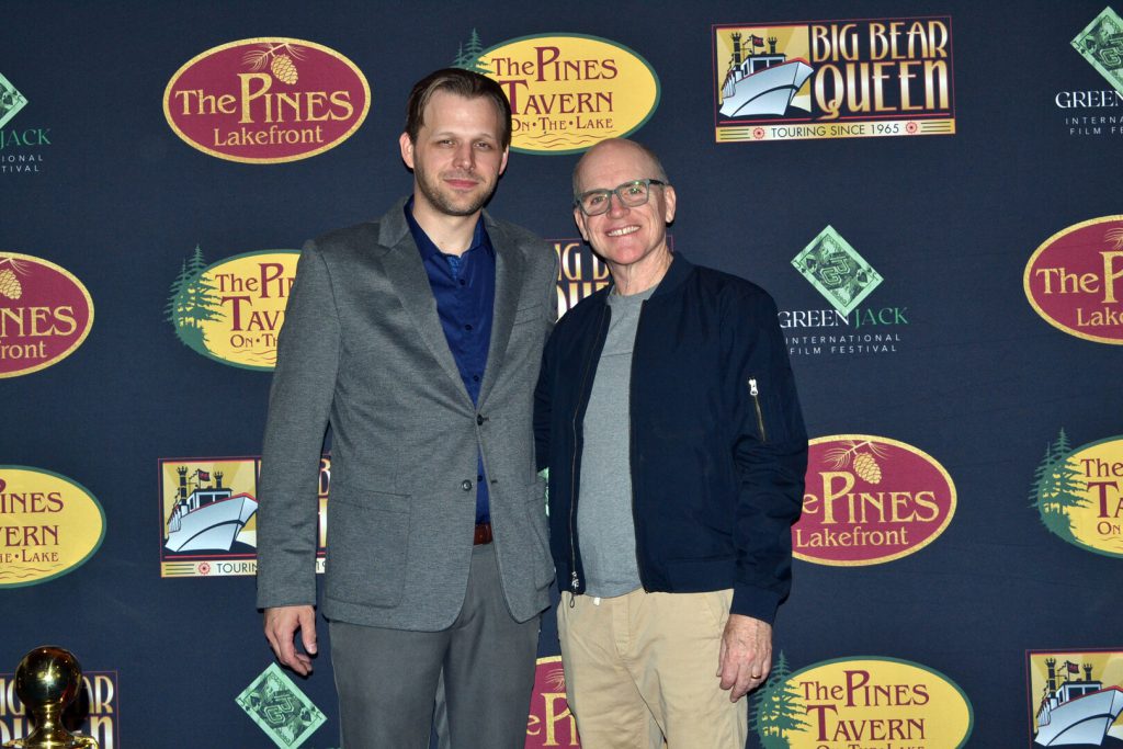 Two men pose together on a red carpet at the Big Bear International Film Festival in Big Bear.