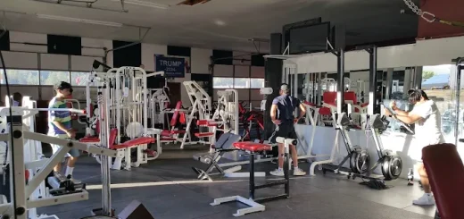 People working out on machines inside Big Bear Total Fitness gym