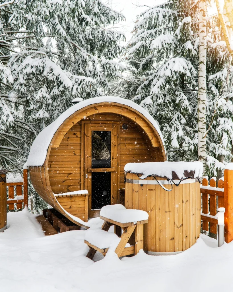 A wooden sauna surrounded by snow, part of the Cold Plunge & Sauna Session Pack in Big Bear.