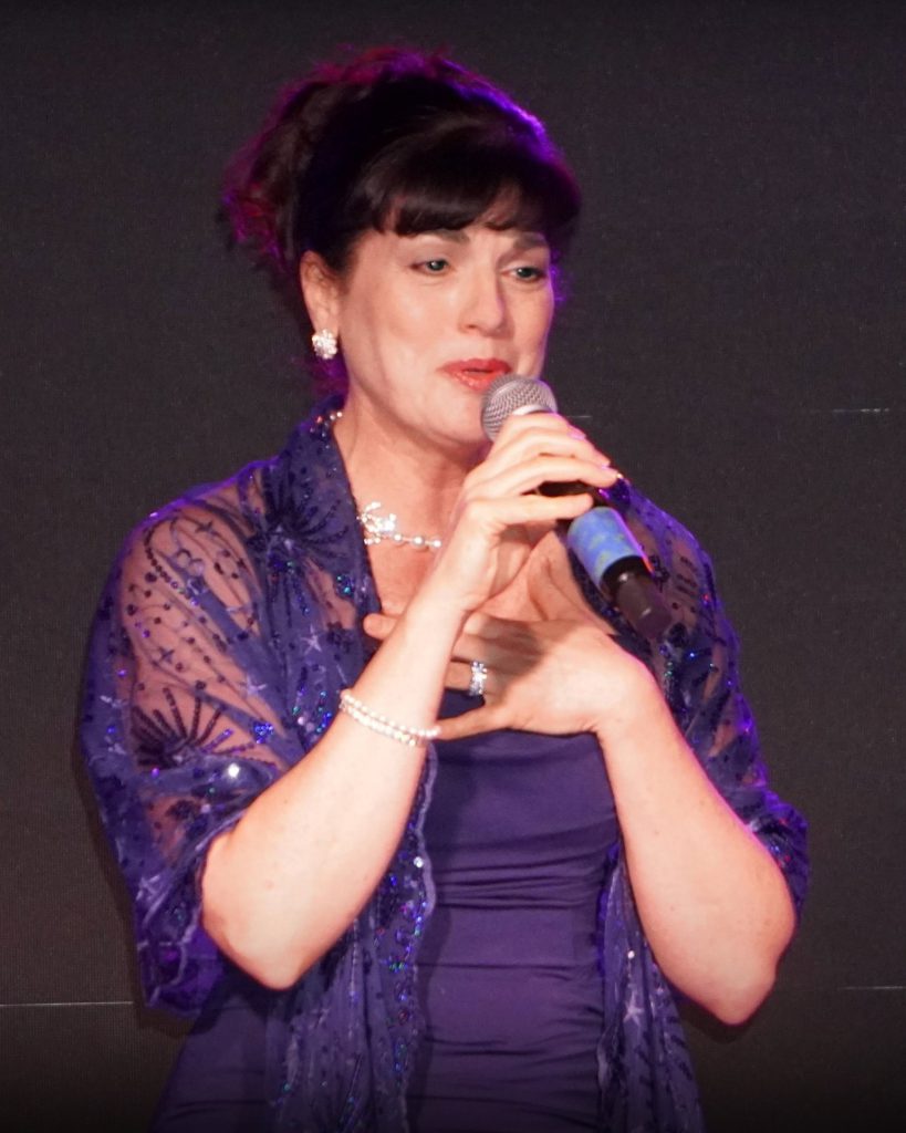 Performer singing live during Golden Voice tribute show in Big Bear