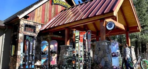 Exterior of Goldsmiths Sports in Big Bear Lake showing skis and snowboards displayed outside the rustic storefront.