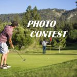 A man in a polo shirt and plaid shorts is about to hit a golf ball on a green with a mountain backdrop, with text overlaying the image that reads "PHOTO CONTEST".