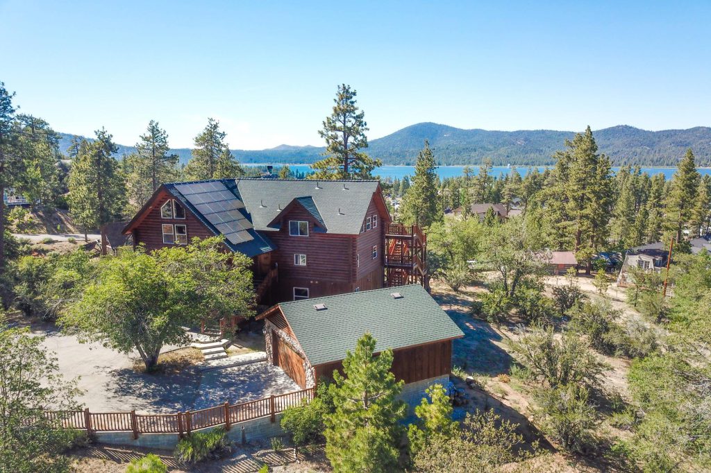 Grand Cameron Estate exterior with solar panels and panoramic views of Big Bear Lake.