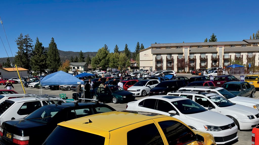 Rows of cars and attendees at Renntober Big Bear automotive event.