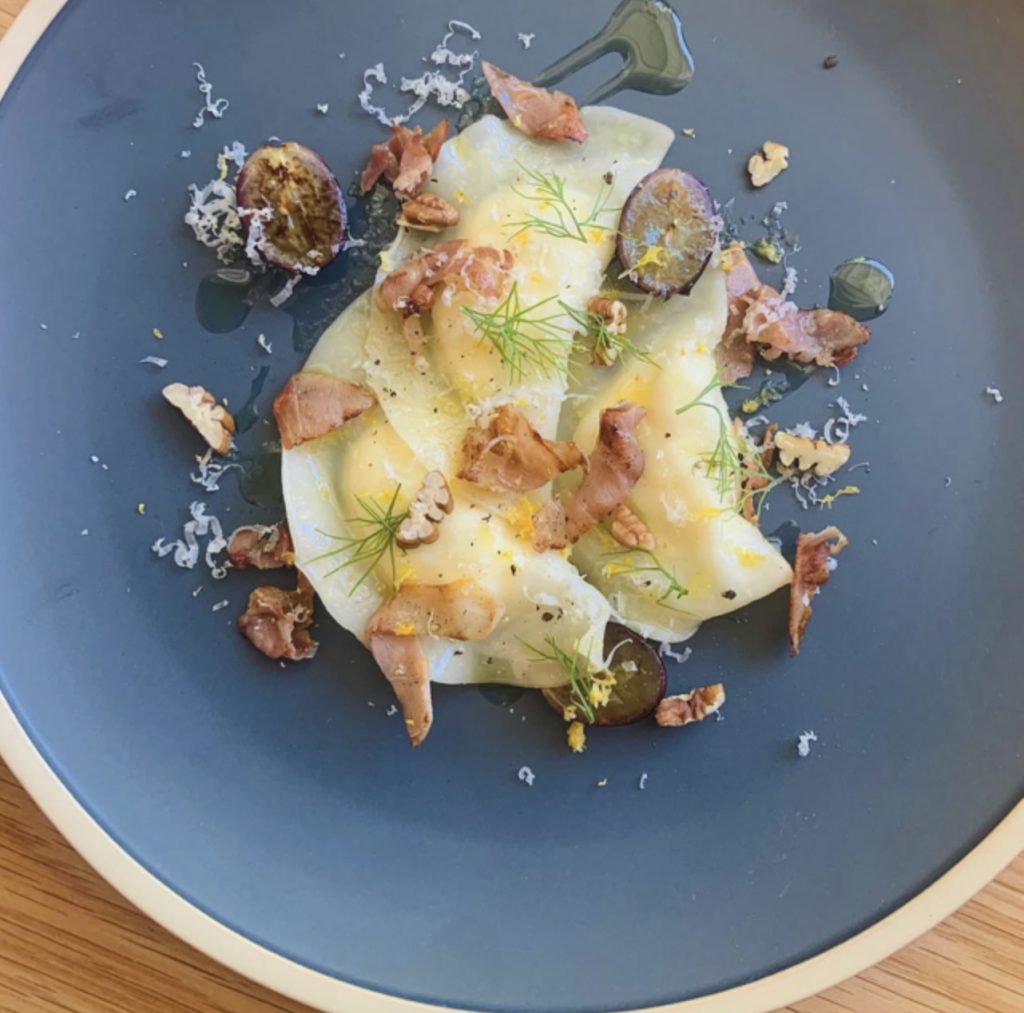 A plate of food with a knife, presented at Dawson the Cook in Big Bear, showcasing a delicious meal.