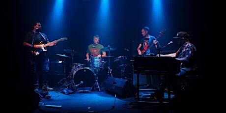 Live band performing under blue stage lights at Sessions Retreat and Hotel in Big Bear Lake