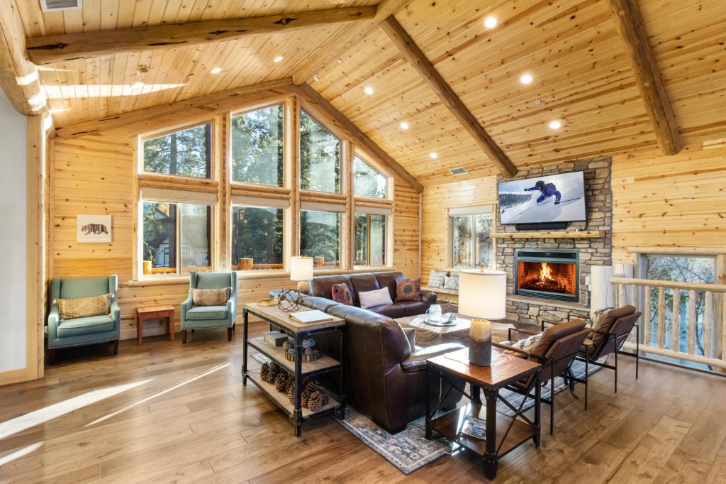 Luna Lodge cozy living room with fireplace and vaulted wood ceiling