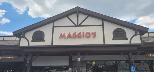 Exterior storefront view of Maggio’s Pizza during daytime in Big Bear Lake shopping center.