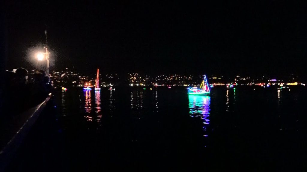 Illuminated boats are seen on the water at night during a boat parade at Big Bear.