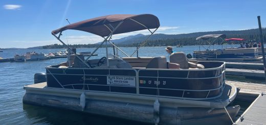 Pontoon boat docked at North Shore Landing on Big Bear Lake with mountain views