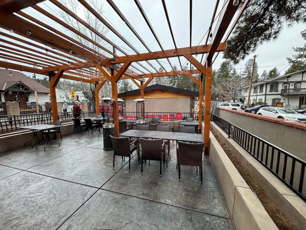 outdoor patio dining area with pergola seating and heaters in Big Bear Lake restaurant