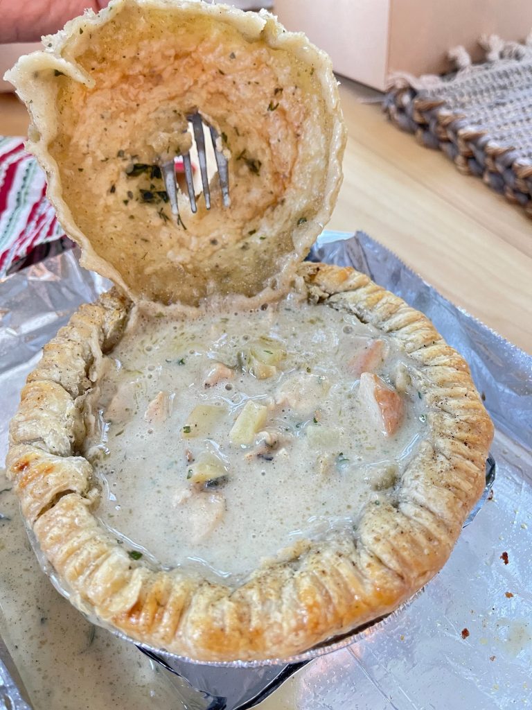 Close-up of a savory pie filled with vegetables and cheese from Pickle’s Pie Shop