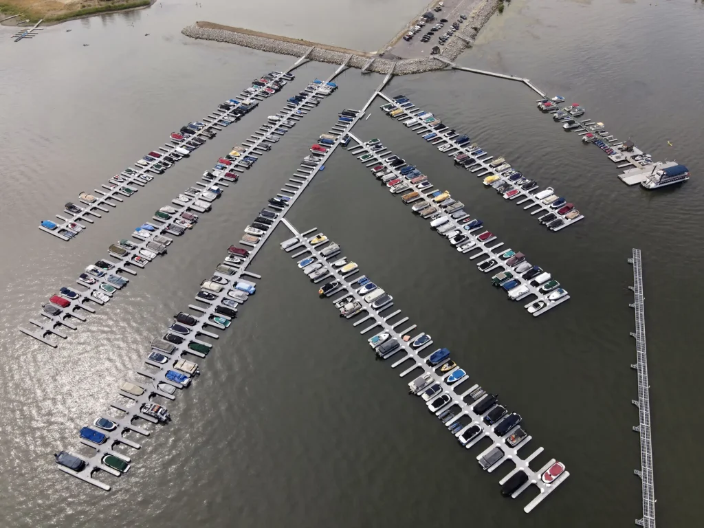 Aerial view of Pine Knot Center marina in Big Bear, showcasing numerous boats docked in the water.